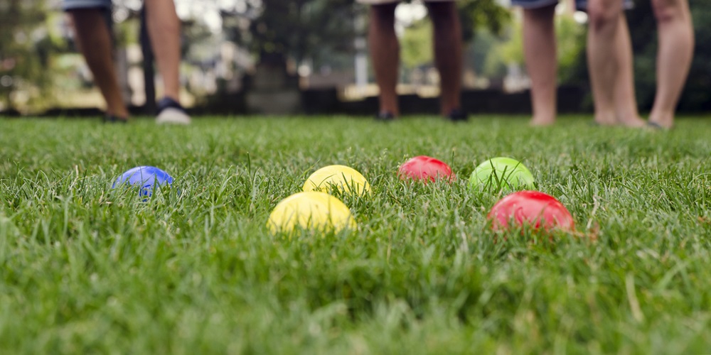 Coloured balls laying in lawn grass